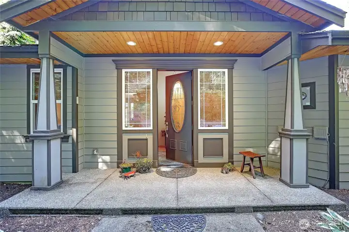 Front door with leaded glass lights. Wide covered porch entry.
