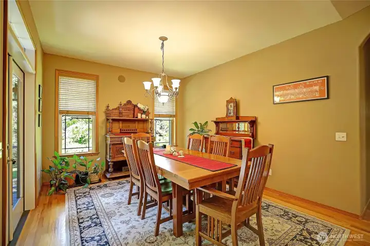 Dining room fairly glows from large windows, full glass doors and transom windows. Gleaming honey oak hardwood floor. Throw open the French doors here and in the Great room for guests to circulate for your parties or large gatherings.