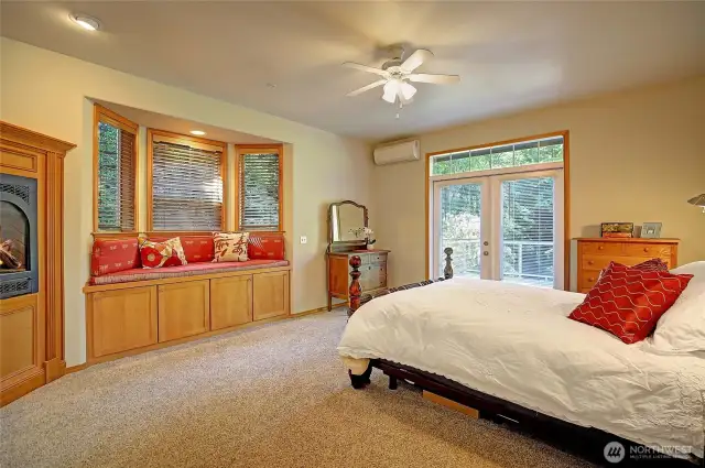 Primary bedroom with French doors that open  to your view deck. High end finishes including wood wrapped windows blinds