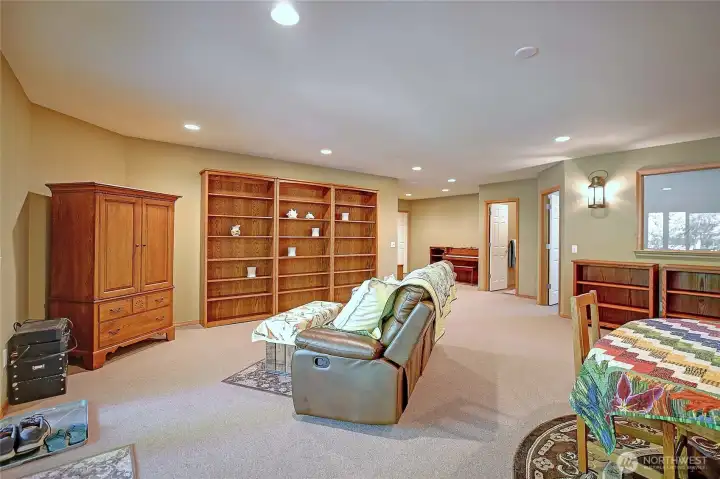 Garden level Rec/media room with gas fireplace, wet bar, wine frig, gym and French doors to covered patio and garden with raised beds