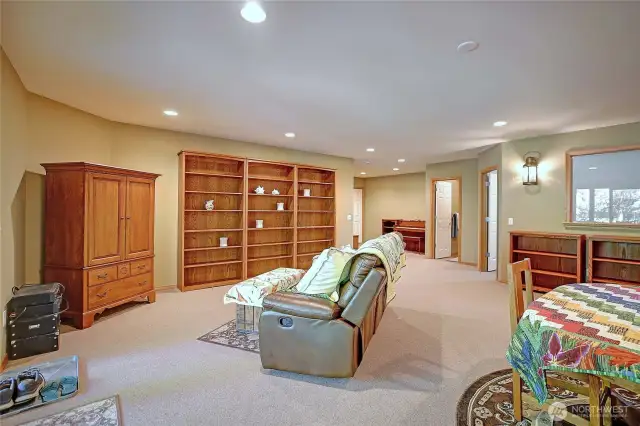 Garden level Rec/media room with gas fireplace, wet bar, wine frig, gym and French doors to covered patio and garden with raised beds