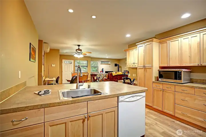 Generously sized apartment kitchen with loads of cabinetry for storage. Dining area with ceiling fan and recessed LED lighting. Mini-split provides year round heating and cooling. Laundry room with Washer, dryer and its own on-demand hot water heater.