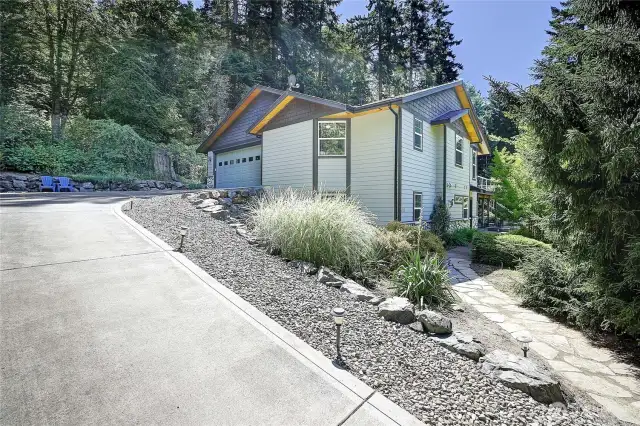Follow the stone path to the lower level entry to Apartment, covered patio, rec room, workshop and private fenced garden.   Paved drive leads to an attached 2 car garage. Garage houses whole house water filer and softener and central vacuum.