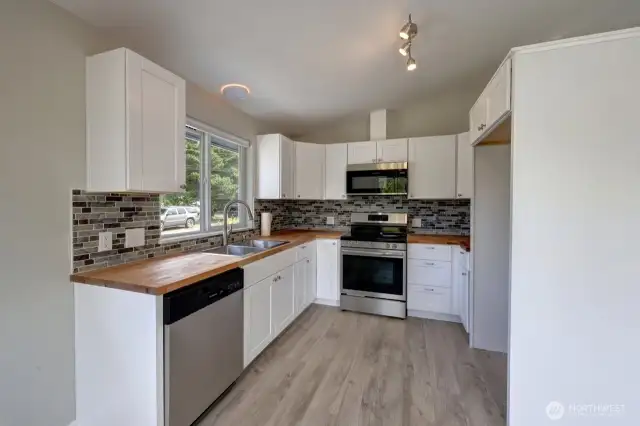 Completely updated kitchen with new flooring, cabinets, fixtures, appliances and lighting.