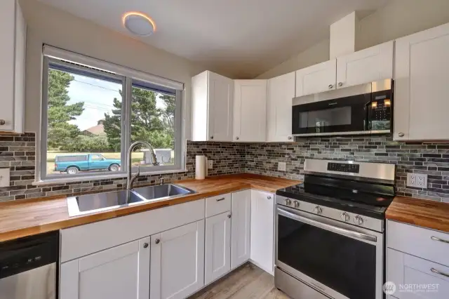 Completely updated kitchen with new flooring, cabinets, fixtures, appliances and lighting.