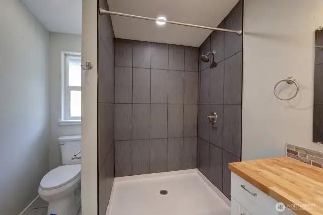 Handicap accessible bathroom with roll in shower.