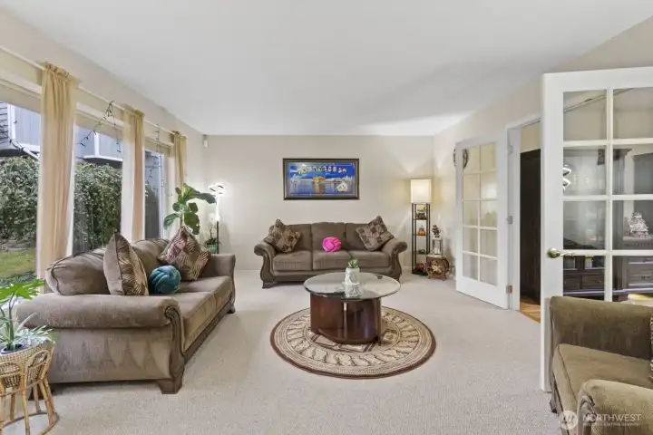 Elegant French doors connect the living and dining room/office, adding a timeless touch to the space.