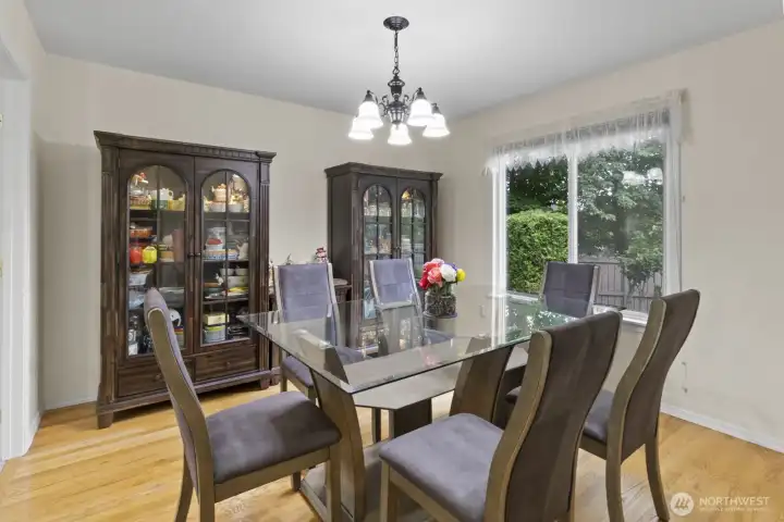French doors lead you get to the formal dining room and features hardwood floors, a stylish chandelier, and a view of the backyard gardens. There’s plenty of room here for gatherings.