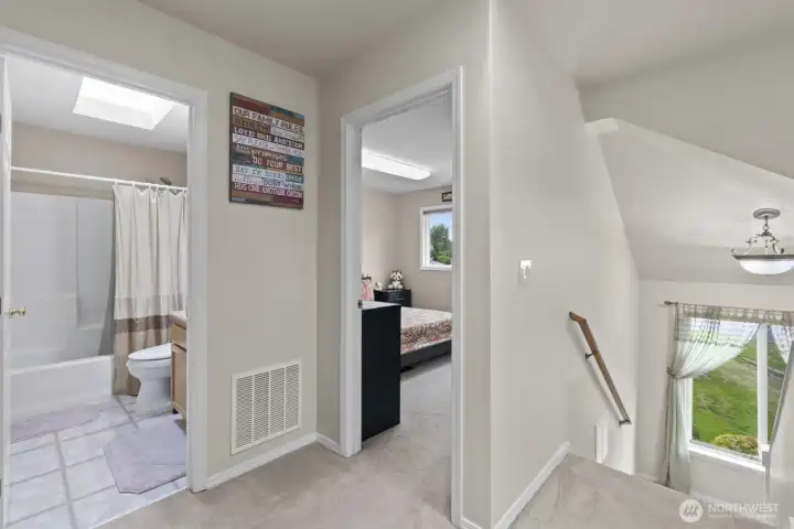 Upstairs offers four bedrooms, including the master suite and a full bathroom, with skylights in the shared bathroom and hallway that flood the space with natural light.