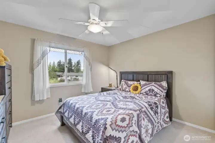 Bedroom two offers generous space and peaceful views of the backyard gardens.