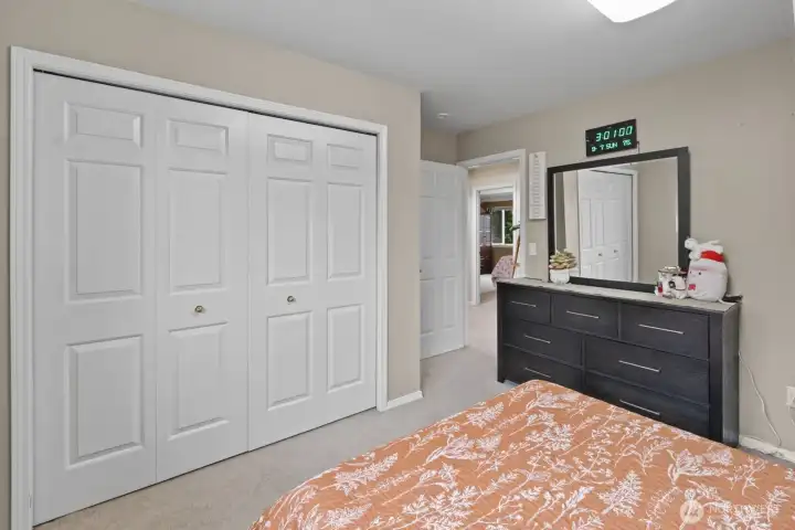 The third bedroom features a built-in double closet and ample space to accommodate a dresser, combining storage and comfort.