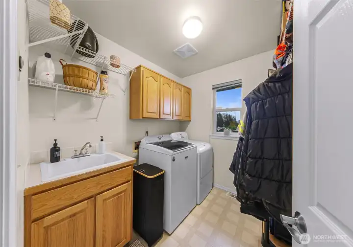 Large Laundry Room with utility sink and additional storage