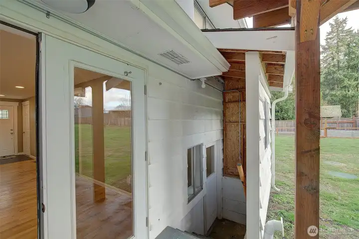 Stairs off of patio leads to utility room on lower level.