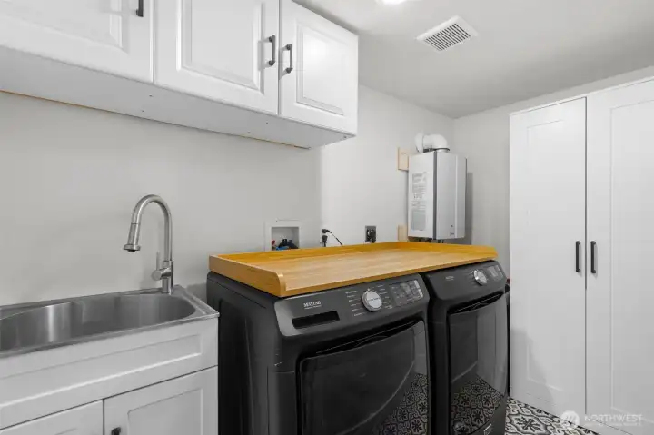Laundry room with sink and storage in lower level