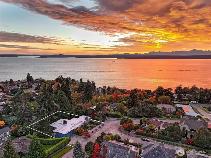 Evening Exterior  Exterior view at dusk, showing interior light and landscape presence.