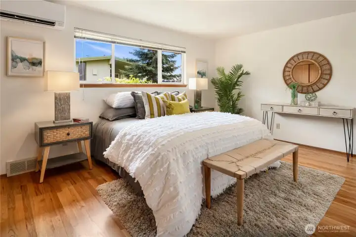 Primary bedroom / suite on the main level, which also has those gleaming red oak hardwoods.
