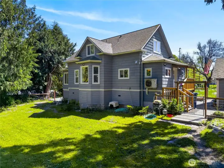 Charming craftsman-style home with inviting outdoor spaces, mature trees, and a peaceful yard that offers privacy and room to enjoy the outdoors.