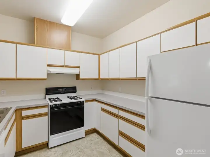 The spacious kitchen is ideally laid out with plenty of cabinet and counter space. The spacious kitchen is ideally laid out with plenty of cabinet and counter space.