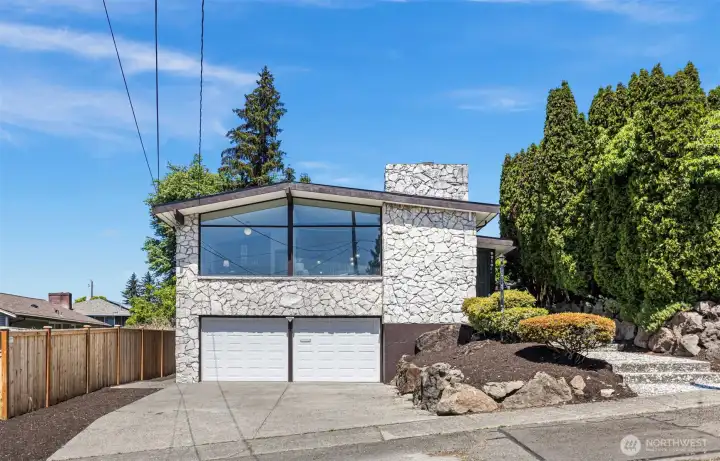 Floor-to-ceiling glass over a 2-car garage. The architecture was always the point.