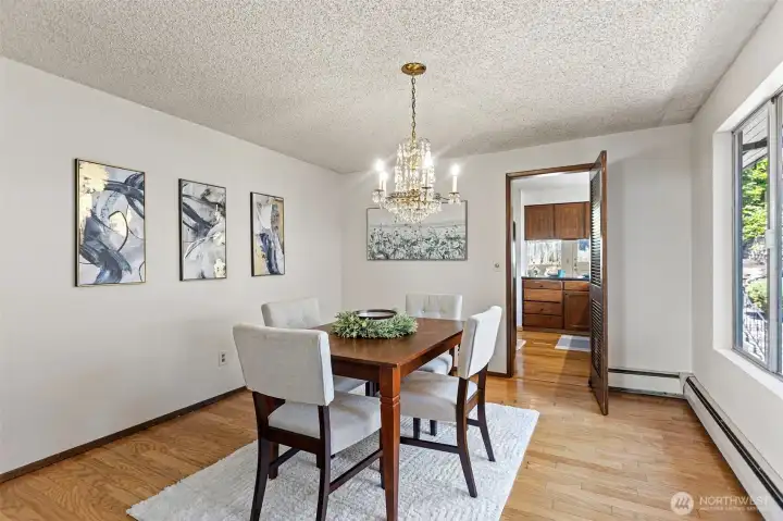 Formal dining, hardwood floor, open to the kitchen. The kind of room that gets used.