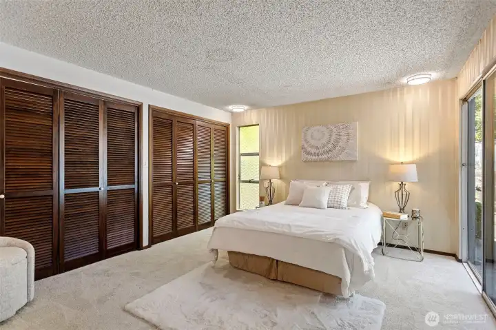 The primary suite is — let's be honest — a master suite. Self-contained escape with two closets, patio access, en suite bath, and room for a king.