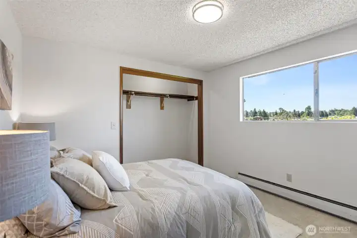 Bedroom 3 — open closet, west-facing territorial view, brand-new carpet. Same story as bedroom 2, different angle.