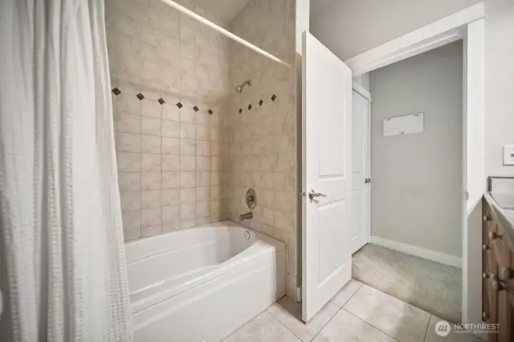 Enjoy the deep soaking tub and attractive tile on shower walls and floor.