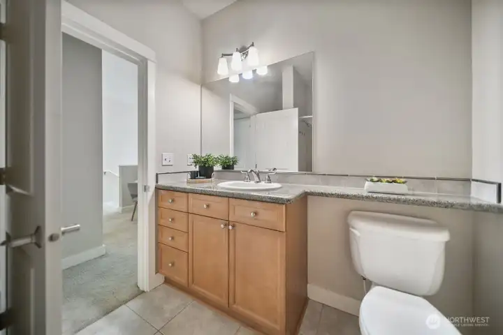 Main bath, single sink vanity with plentiful storage.