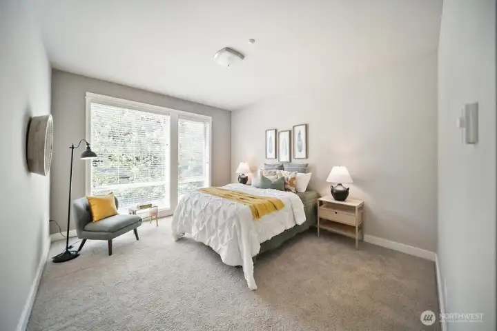 West facing bedroom enjoys large windows and blinds.