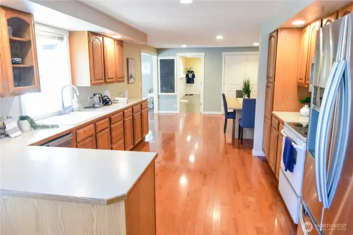 Kitchen has ample storage space, island for your bar stools. Dining area and laundry/ mud room door to the left of the dining area.
