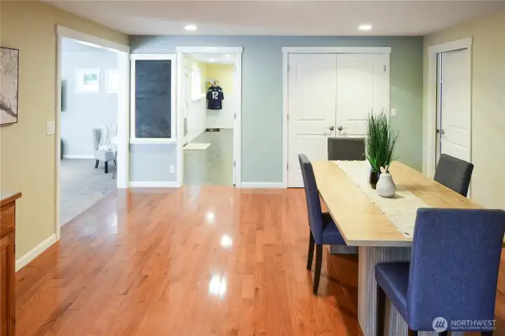Generous sized dining room can host large thanksgiving gatherings. Door on right side leads to garage. Another garage door leads into the mud room/ drop zone for shoes and jackets. Cupboard for all your dining items or board games. To the left is the added giant TV/family room with vaulted ceilings.