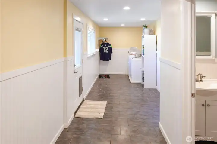 This laundry room is huge. A mud room, A drop space for jackets and shoes. An adjoining bathroom with shower serves as a quest bathroom and place to clean off dogs after a walk.