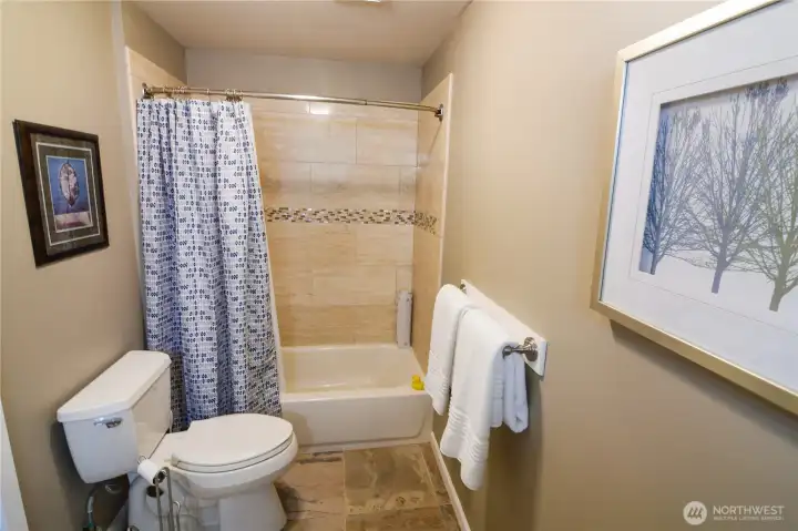 Updated shower tiles with bath makes this a full bathroom serving the 3 bedrooms across the hallway.