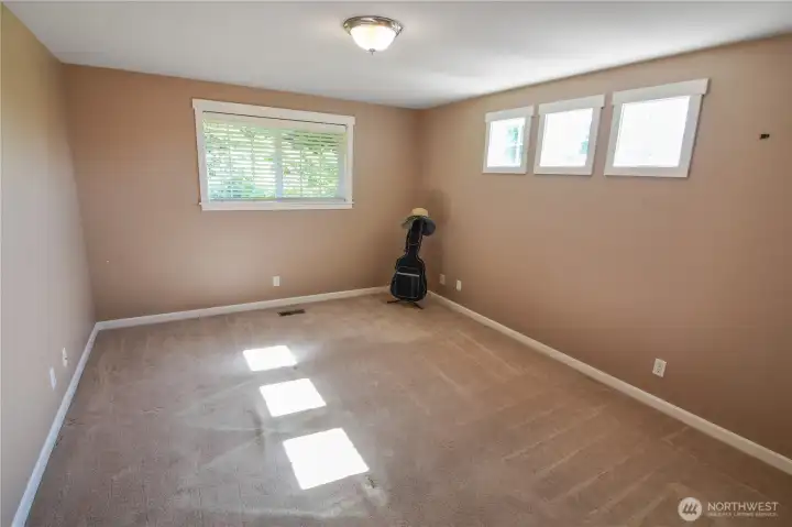3rd of 4 bedrooms is standard size with windows and generous closet space.