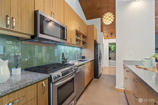 Colorful tile, gas cooking, stainless appliances and ample storage space build a kitchen that'll please any chef!