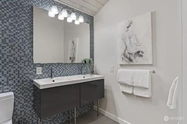 Stylishly appointed with colorful tile and modern fixtures, this primary bath is so chic!