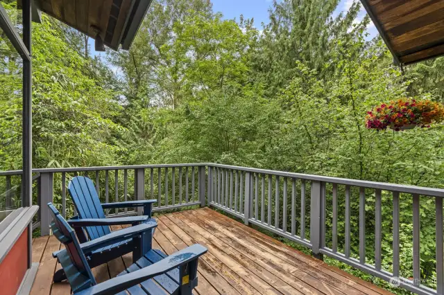 The spacious deck off of the kitchen is perfect for summer BBQs and relaxing while birds sing above and Thornton Creek babbles below.