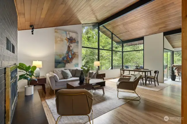 Hard-to-find clear cedar post and beam ceilings and large windows create a warm, inviting living space.
