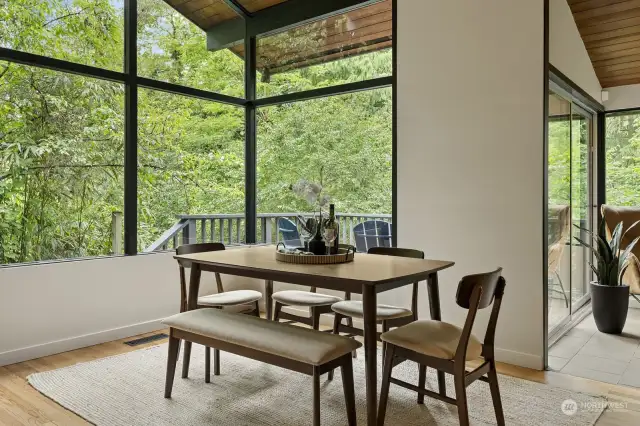 The dining area takes in serene wooded views for incredible meals any time of year.