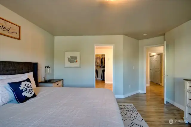 Primary bedroom looking towards bathroom and hallway on right.