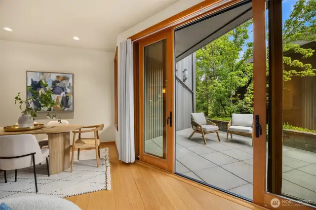 The inviting patio offers a sunny place to enjoy the greenery, as well as a sheltered area for those days of misty rain.
