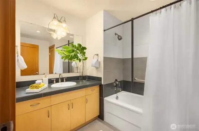 The primary bathroom’s finishes continue the them of the rest of the home – timeless, understated, and refined. The tub/shower offers an unobtrusive pull-up bar for those who may appreciate this handy feature.