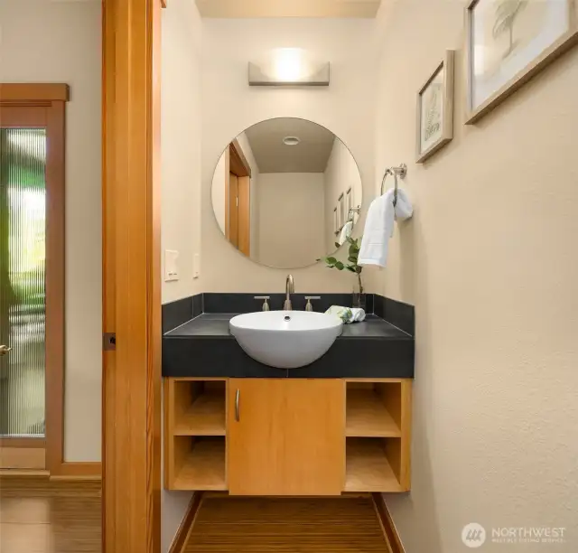 The classy powder room is directly adjacent to the front entry, tucked away from the main living spaces. So many thoughtful design choices make this home a pleasure for the homeowner and visitors alike.