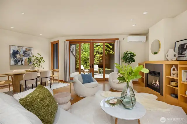 We begin in the tasteful and cheery sitting area of the great room, where maple built-ins flank a stylish propane fireplace, and substantial wood-clad fiberglass sliding doors open to the sunny and exceptionally private patio.