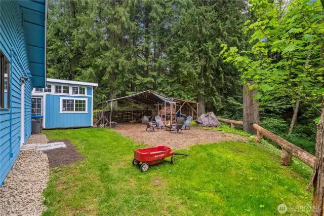 The side yard, sits next to one of windowed out buildings . Many beautiful areas to look onto territorial views of serenity of the property.