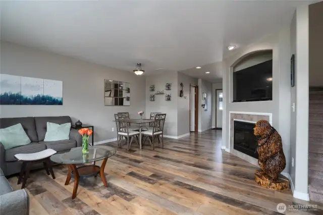 Step inside to the living room featuring laminate flooring and electric fireplace.