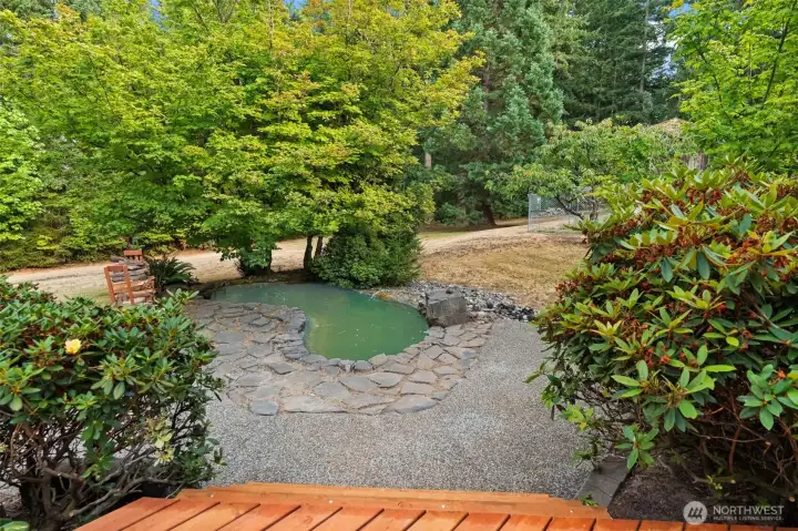Back Yard -Beautiful koi pond in the backyard surrounded by lush landscaping. A peaceful, private spot perfect for relaxing, enjoying nature, or adding your personal touches.