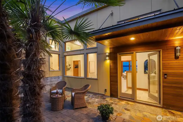 The property starts along Maplewild (see the aerial picture highlighting the approximate boundaries of the parcel), flows into the substantial parking area (rare feature on the water locally) and to the fenced courtyard and main home entrance.