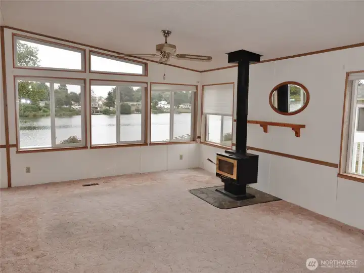 Living Room w/ wood-burning free-standing fireplace.