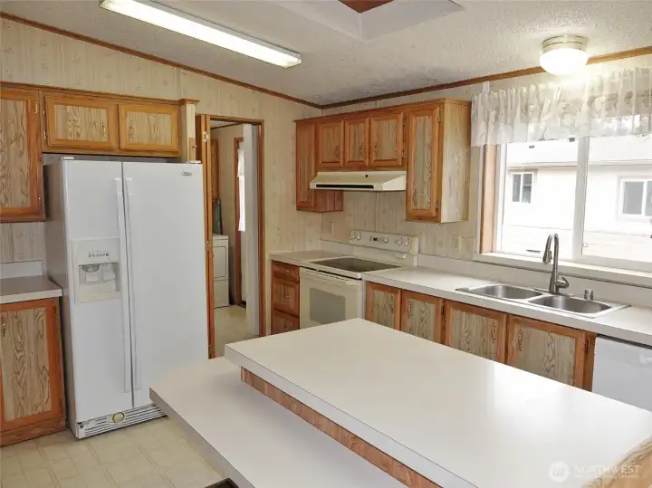 Lots of cabinets and counter space. The kitchen leads into the Laundry Room.